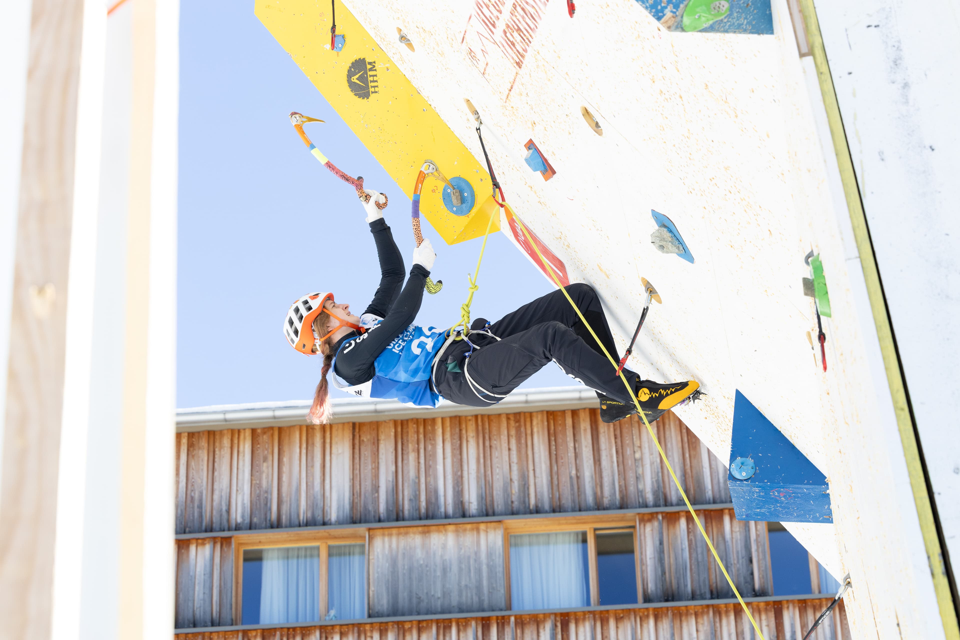 Youth athlete competing on ice climbing wall