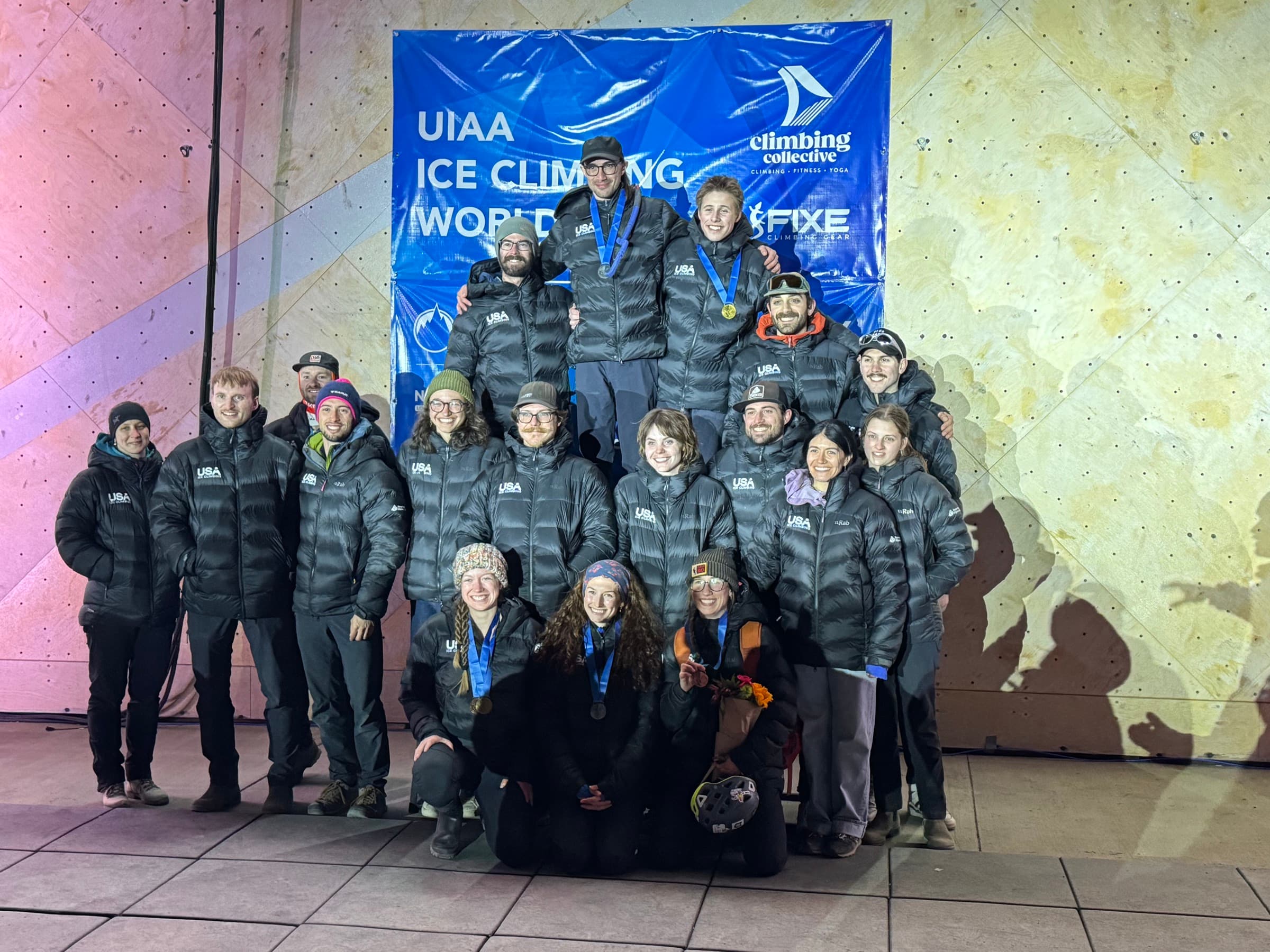 The USA Ice Climbing team celebrating with medals at the UIAA Ice Climbing World Cup at Longmont Climbing Collective